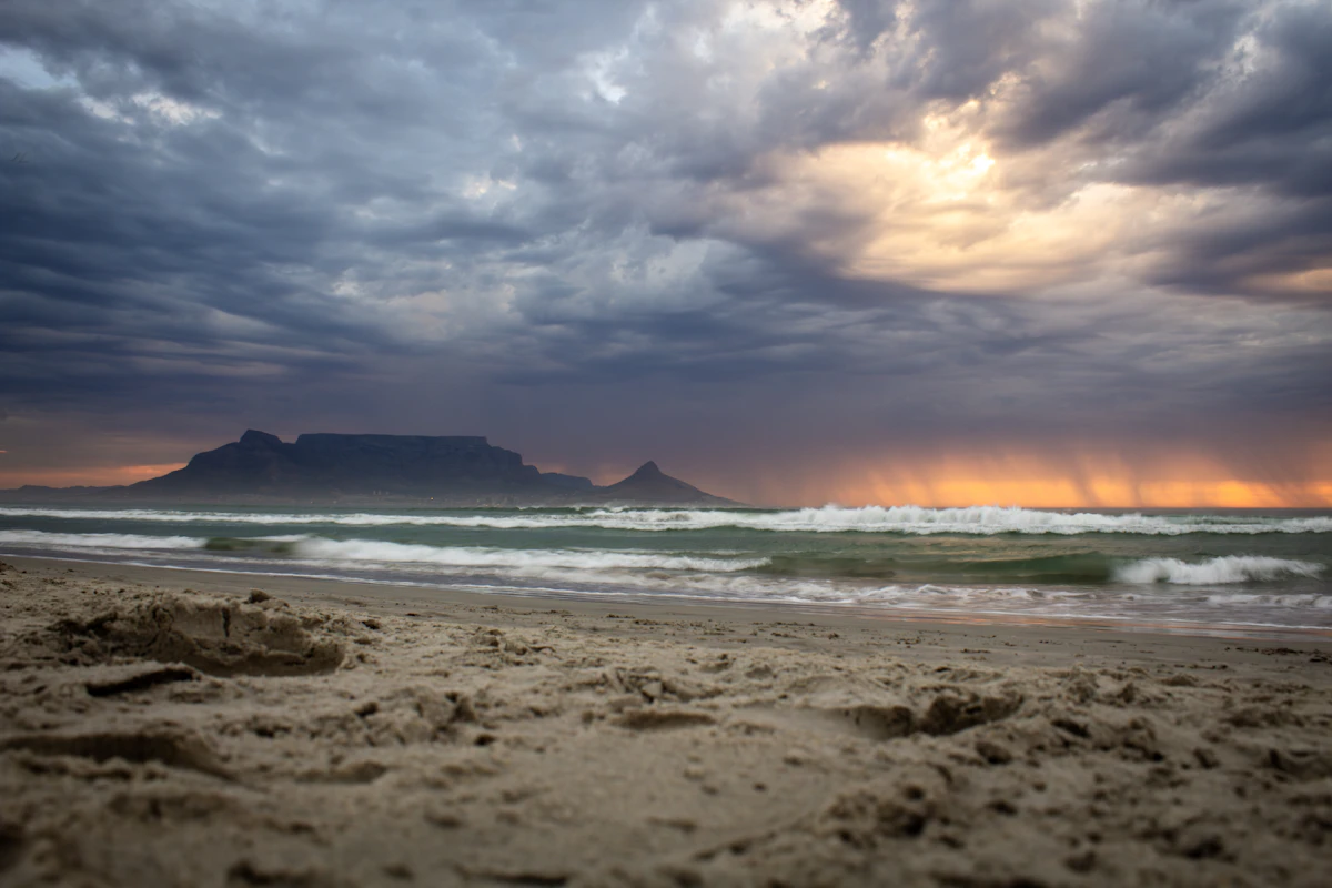 Table Mountain in silhouette across the water from Bloubergstrand, Cape Town
