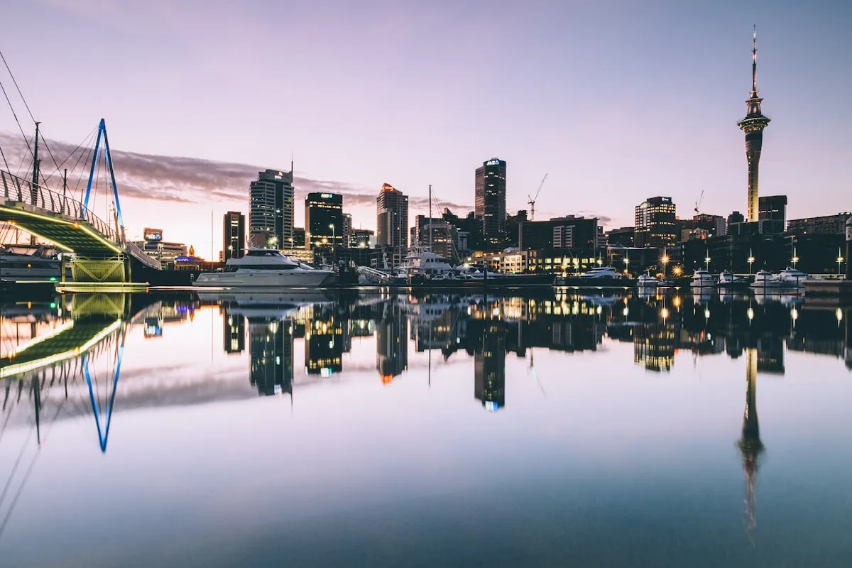 Auckland waterfront mirrored in still water at dusk
